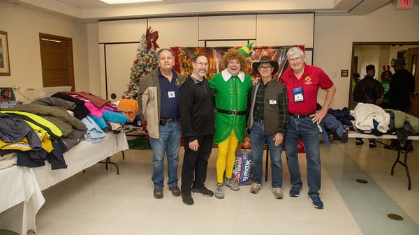 Council 12906 volunteers gathered beside donated coats